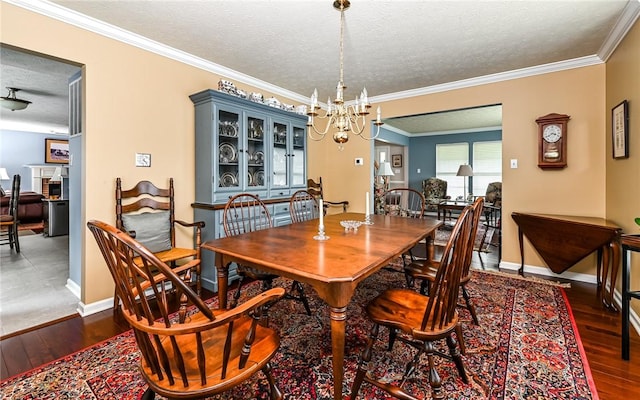 489 Jenny Dr, Richland, PA 15044 - dining room with a textured ceiling, a chandelier, hardwood / wood-style flooring, crown molding, and a fireplace