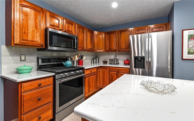 489 Jenny Dr, Richland, PA 15044 - kitchen featuring stainless steel appliances, light countertops, tasteful backsplash, brown cabinetry, and a textured ceiling