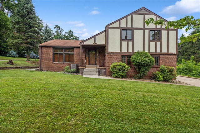 982 Braddock Rd, Forest Hills Boro, PA 15221 - tudor-style house featuring brick siding, a front yard, and stucco siding
