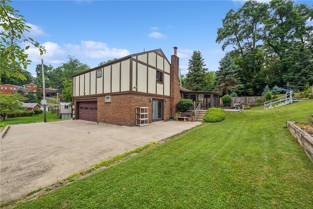 982 Braddock Rd, Forest Hills Boro, PA 15221 - view of property exterior with brick siding, an attached garage, a chimney, concrete driveway, and a sunroom