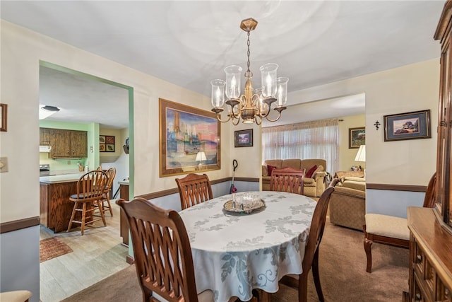 982 Braddock Rd, Forest Hills Boro, PA 15221 - dining area with a chandelier and light wood-style flooring