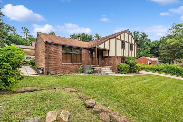 982 Braddock Rd, Forest Hills Boro, PA 15221 - tudor house featuring brick siding, a front lawn, and a shingled roof