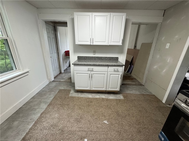21 Hodgson Ave, Ingram, PA 15205 - kitchen featuring white cabinetry, dark countertops, and range