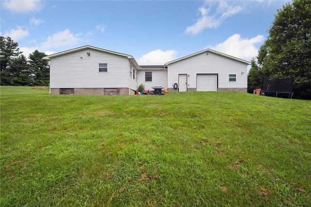 4 Ward St, Canton Twp, PA 15301 - back of property featuring a trampoline, a lawn, and an attached garage