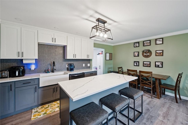 4 Ward St, Canton Twp, PA 15301 - kitchen with a kitchen breakfast bar, backsplash, ornamental molding, light wood-style floors, and white cabinetry