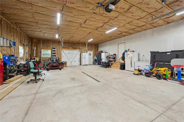 4 Ward St, Canton Twp, PA 15301 - garage featuring freestanding refrigerator, a garage door opener, and water heater