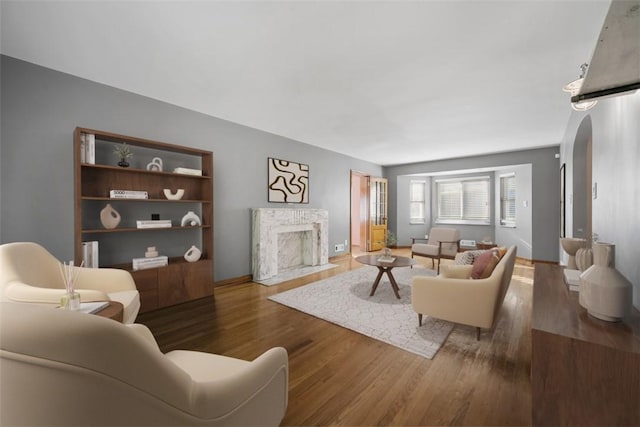 7604 Tyler Rd, Verona, PA 15147 - living area with a fireplace, wood finished floors, and arched walkways
