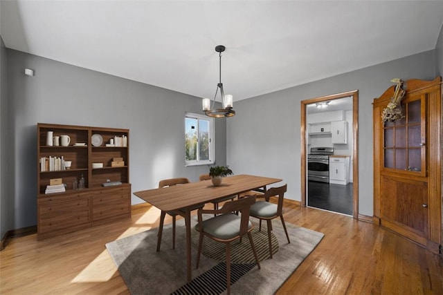 7604 Tyler Rd, Verona, PA 15147 - dining area featuring light wood-style flooring and a chandelier