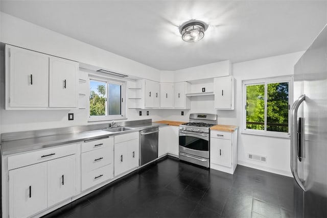 7604 Tyler Rd, Verona, PA 15147 - kitchen with stainless steel counters, appliances with stainless steel finishes, open shelves, and white cabinetry