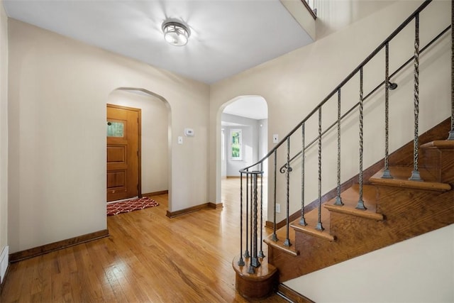 7604 Tyler Rd, Verona, PA 15147 - foyer with arched walkways, wood finished floors, and stairs