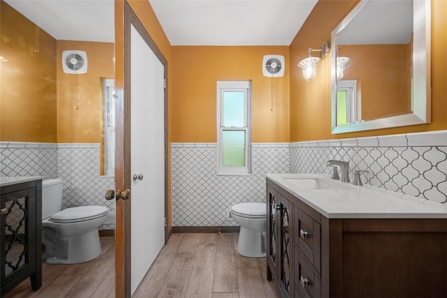 7604 Tyler Rd, Verona, PA 15147 - bathroom featuring tile walls, wainscoting, vanity, and wood finished floors