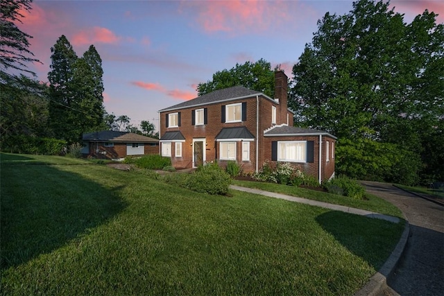 7604 Tyler Rd, Verona, PA 15147 - view of front of house with a chimney, a front yard, and brick siding