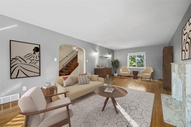 7604 Tyler Rd, Verona, PA 15147 - living room with wood finished floors, arched walkways, and stairs