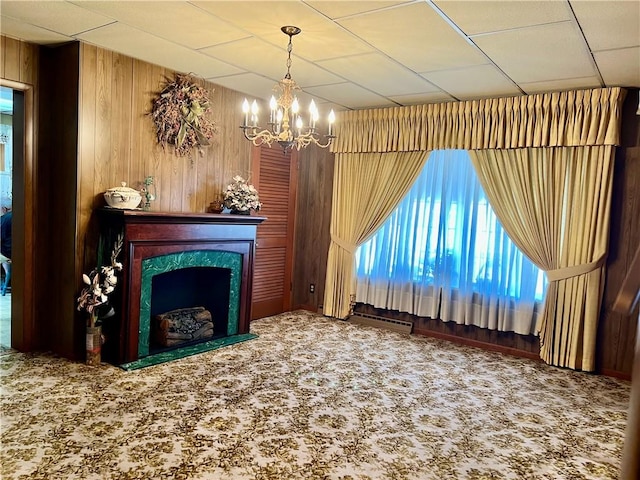 229 Fallowfield Ave, Charleroi Boro, PA 15022 - carpeted living area featuring a chandelier, wood walls, a fireplace, and a drop ceiling