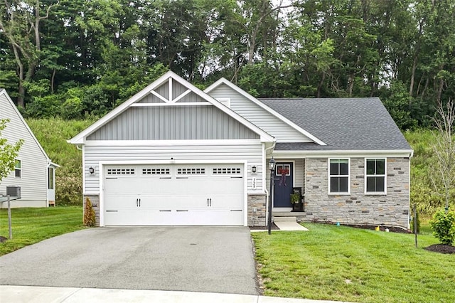329 Nelson Dr, Monroeville, PA 15146 - view of front of house with stone siding, board and batten siding, asphalt driveway, a garage, and a front lawn