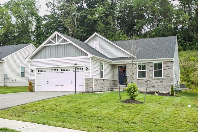 329 Nelson Dr, Monroeville, PA 15146 - view of front of property with stone siding, a garage, driveway, board and batten siding, and a front lawn