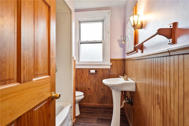1477 Benton Ave, Brighton Heights, PA 15212 - bathroom with a wainscoted wall, wood finished floors, a bathtub, and wooden walls