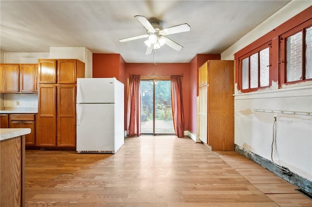 1477 Benton Ave, Brighton Heights, PA 15212 - kitchen with freestanding refrigerator, ceiling fan, light countertops, and brown cabinetry