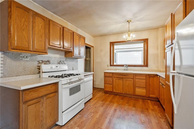 1477 Benton Ave, Brighton Heights, PA 15212 - kitchen featuring white appliances, decorative backsplash, light wood-type flooring, light countertops, and a chandelier