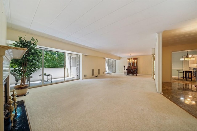 53 Highland Rd Unit 403-404, Bethel Park, PA 15102 - unfurnished living room with a chandelier, a fireplace, and carpet floors