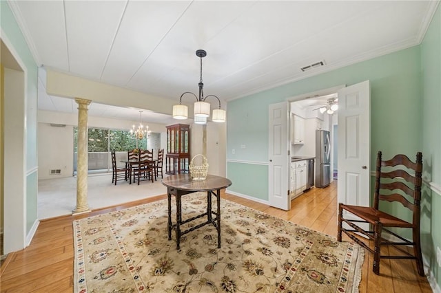 53 Highland Rd Unit 403-404, Bethel Park, PA 15102 - dining space with light wood-style flooring, a chandelier, ornamental molding, and ornate columns