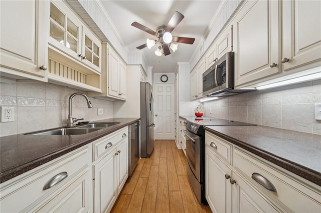 53 Highland Rd Unit 403-404, Bethel Park, PA 15102 - kitchen with appliances with stainless steel finishes, light wood-type flooring, dark countertops, ceiling fan, and ornamental molding