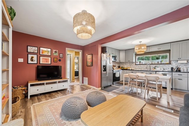 1021 Beechnut St, West Deer, PA 15084 - living area with a chandelier and light wood-type flooring