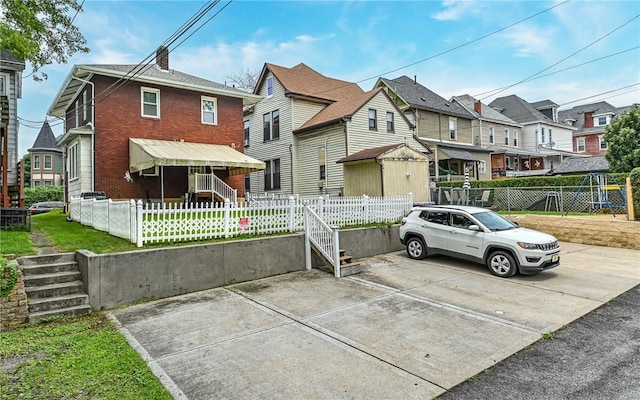 112 Fisk Ave, Avalon, PA 15202 - view of front facade featuring a fenced front yard, a residential view, and brick siding