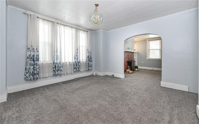 112 Fisk Ave, Avalon, PA 15202 - carpeted spare room featuring arched walkways, a chandelier, a fireplace, and crown molding