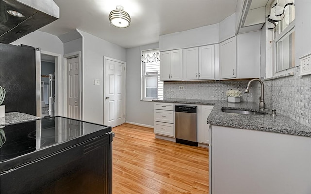112 Fisk Ave, Avalon, PA 15202 - kitchen featuring appliances with stainless steel finishes, backsplash, light wood-style flooring, dark stone counters, and white cabinets