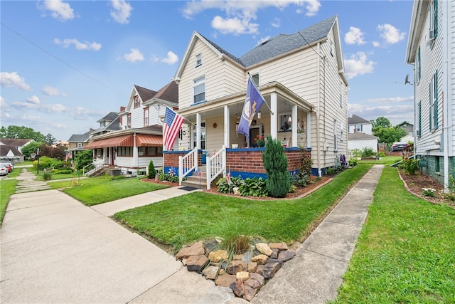 332 S Chestnut St, Scottdale, PA 15683 - view of front of home featuring a porch, a front lawn, and a residential view