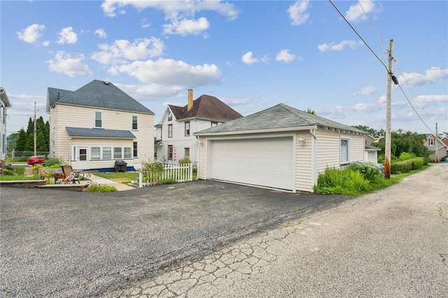 332 S Chestnut St, Scottdale, PA 15683 - view of front of home with a detached garage, an outbuilding, and roof with shingles