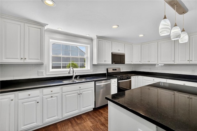 235 Telegraph Rd, Luzerne Twp, PA 15417 - kitchen with stainless steel appliances, dark countertops, and white cabinetry