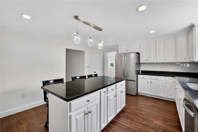 235 Telegraph Rd, Luzerne Twp, PA 15417 - kitchen with appliances with stainless steel finishes, white cabinetry, dark countertops, ornamental molding, and recessed lighting