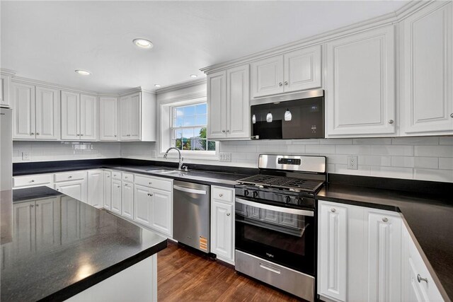 235 Telegraph Rd, Luzerne Twp, PA 15417 - kitchen featuring stainless steel appliances, dark countertops, white cabinets, dark wood-type flooring, and recessed lighting
