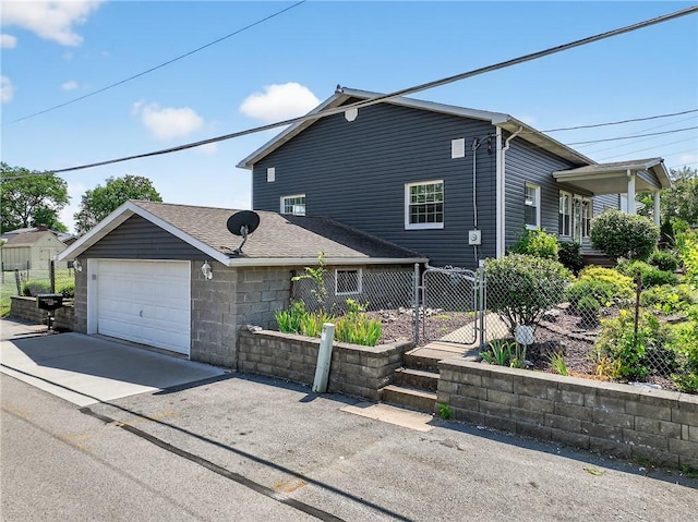 235 Telegraph Rd, Luzerne Twp, PA 15417 - view of front of home with concrete driveway, an attached garage, a gate, and a shingled roof