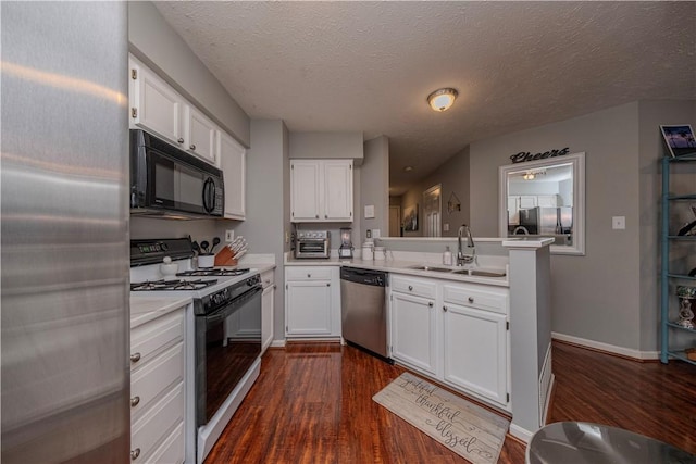 115 Westbrooke Ln, Findlay Twp, PA 15108 - kitchen with stainless steel appliances, dark wood finished floors, white cabinets, and a textured ceiling