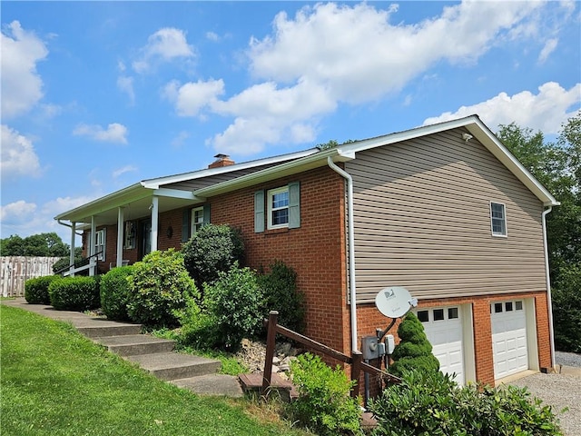 323 Hoon Rd, Oakland Twp, PA 16001 - view of property exterior with brick siding, a chimney, an attached garage, and gravel driveway