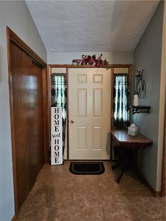323 Hoon Rd, Oakland Twp, PA 16001 - foyer entrance with dark tile patterned flooring and a textured ceiling