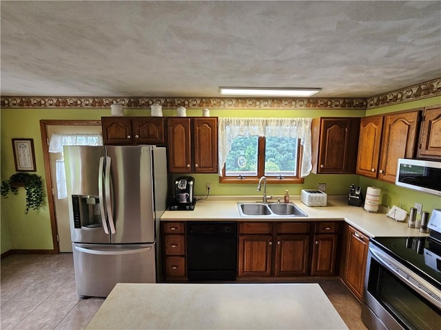 323 Hoon Rd, Oakland Twp, PA 16001 - kitchen with stainless steel appliances, light countertops, and light tile patterned floors