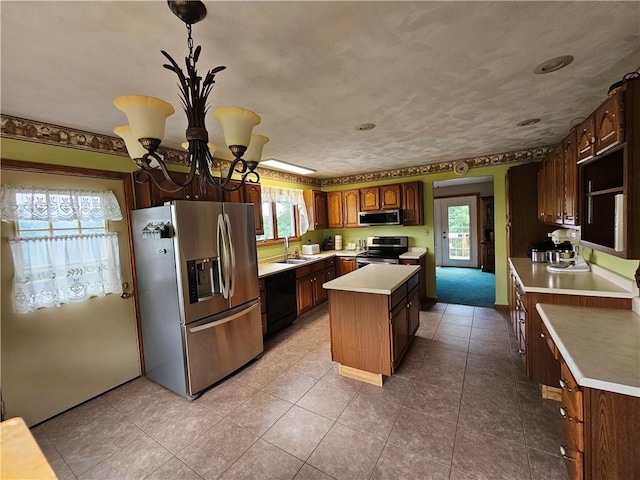323 Hoon Rd, Oakland Twp, PA 16001 - kitchen with appliances with stainless steel finishes, a kitchen island, healthy amount of natural light, and a chandelier