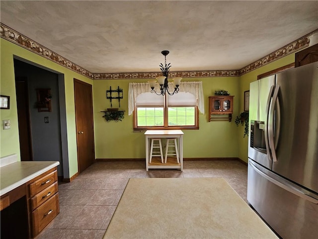 323 Hoon Rd, Oakland Twp, PA 16001 - kitchen featuring stainless steel refrigerator with ice dispenser, a chandelier, tile patterned flooring, light countertops, and decorative light fixtures