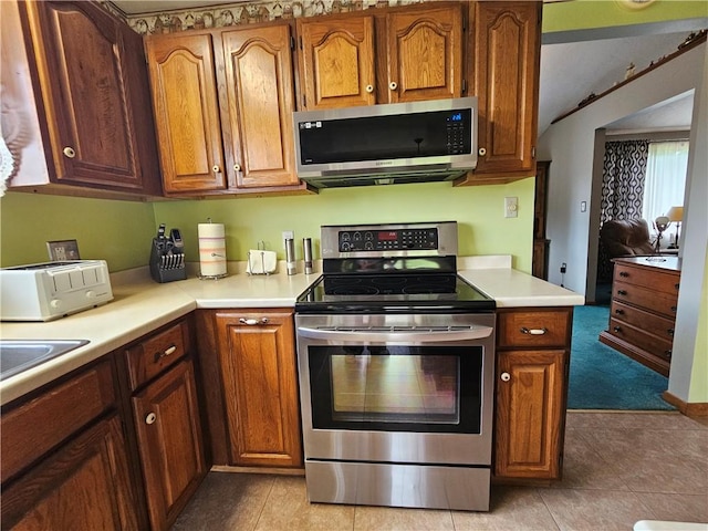 323 Hoon Rd, Oakland Twp, PA 16001 - kitchen with appliances with stainless steel finishes, light countertops, brown cabinets, and vaulted ceiling