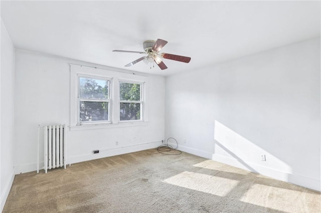 357 Keystone Dr, New Kensington, PA 15068 - spare room featuring radiator heating unit, carpet floors, and a ceiling fan