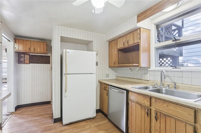 357 Keystone Dr, New Kensington, PA 15068 - kitchen with freestanding refrigerator, stainless steel dishwasher, light wood-type flooring, light countertops, and wallpapered walls