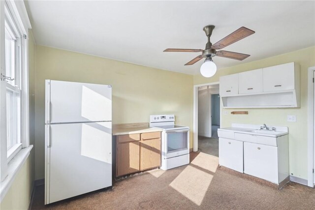 357 Keystone Dr, New Kensington, PA 15068 - kitchen with white appliances, light colored carpet, a ceiling fan, and light countertops