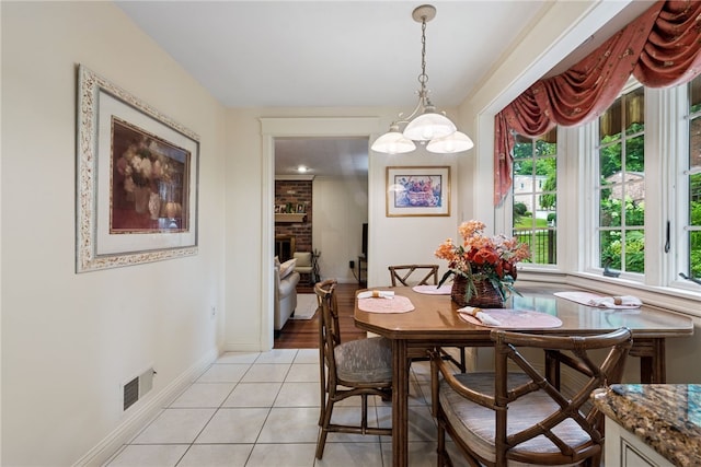 511 Brunswick Dr, Hempfield Twp, PA 15601 - dining area featuring light tile patterned floors and a brick fireplace