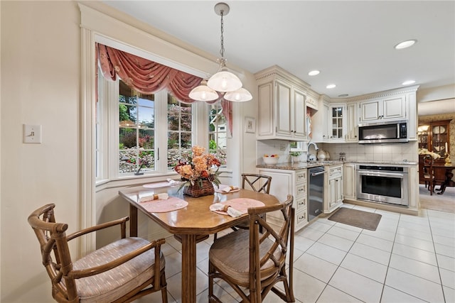 511 Brunswick Dr, Hempfield Twp, PA 15601 - dining space with light tile patterned floors and recessed lighting