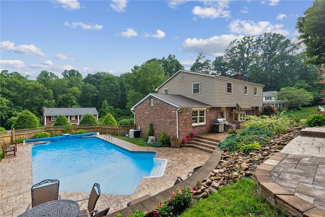 511 Brunswick Dr, Hempfield Twp, PA 15601 - view of swimming pool with a fenced backyard, area for grilling, and a patio area