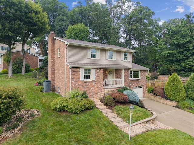 511 Brunswick Dr, Hempfield Twp, PA 15601 - traditional home featuring concrete driveway, a chimney, brick siding, a garage, and a porch